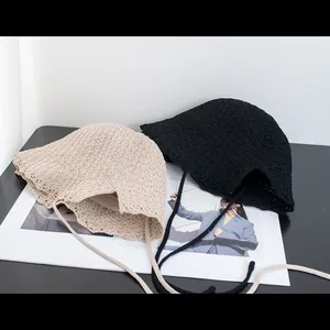 Lace-edged crochet bucket hats in beige and black with stylish self-tie straps