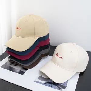 Minimalist cotton baseball cap with red Me embroidery shown in various colors