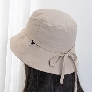 Women's lightweight sun hat in beige with ponytail hole and bow tie detail