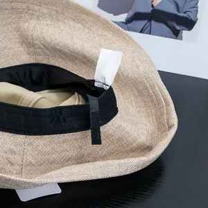 Adjustable Hepburn style sun hat with wide brim, interior sweatband and sizing cord