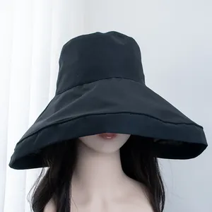 Close-up of women's black wide-brim sun hat with UV protection for superior face shading