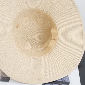 Adjustable beige straw beach hat with UV protection and breathable woven texture