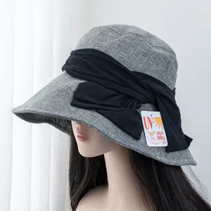 Detail of UV protection sun hat featuring a large elegant bow and breathable fabric