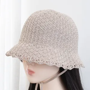 Detail of summer sun hat with hollow crochet knit texture and stylish wavy lace brim