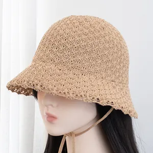 Chic beige straw bucket hat with scalloped brim and adjustable drawstring for sun protection