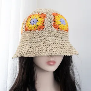 Detail of handmade crochet sun hat with colorful flower patterns and breathable woven texture