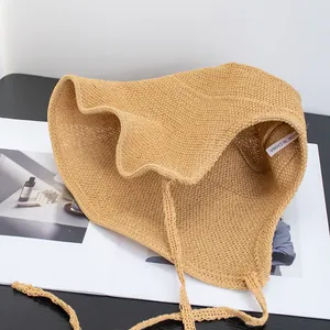 Japanese style woven straw sun hat for women with wavy brim and vintage ribbon ties