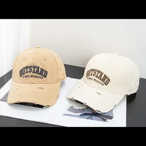 Close-up of vintage distressed cotton baseball caps with OUTSTAND 3D embroidery detail