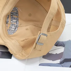 Rear view of khaki washed cotton baseball cap with adjustable strap and inner embroidery