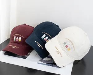 Close-up of cute rabbit embroidery and Play Skateboarding text on cotton baseball caps