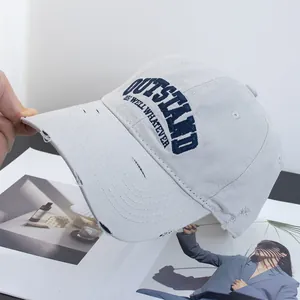 Macro detail of distressed cotton baseball cap with blue OUTSTAND 3D embroidery