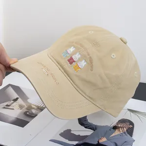 Close-up of cute rabbit embroidery on a khaki cotton baseball cap with text details