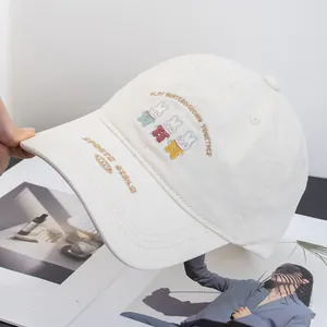 Close-up of cute cartoon rabbit embroidery on a cream cotton baseball cap