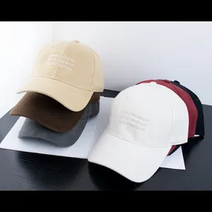 Detailed embroidery on colorful cotton baseball caps with a focus on fabric texture