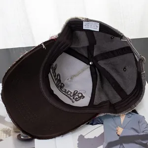Detail of vintage washed cotton baseball cap with raw edges and 100% cotton wash label