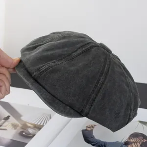 Detailed close-up of dark grey washed cotton octagonal cap with reinforced stitching