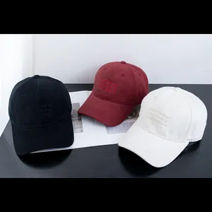 Three cotton baseball caps in black, burgundy, and white with embroidered letters