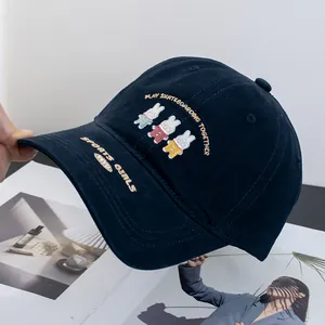 Detailed embroidery of three cartoon rabbits on a navy cotton baseball cap for women