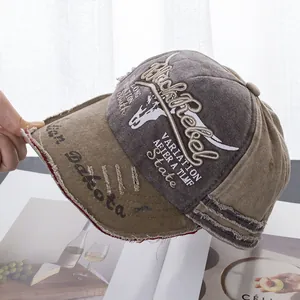 Close-up of distressed denim baseball cap with Black Rebel embroidery and frayed edges