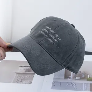 Detail of dark grey cotton baseball cap with embroidered geometric triangle patterns