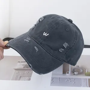 Détails d'une casquette de baseball gris foncé délavée avec broderie W blanche rétro
