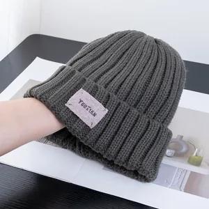 Detailed knit texture of dark grey ribbed beanie with YOUTIAN label and stretch view