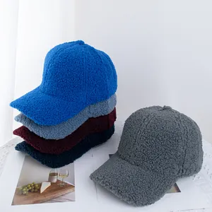 Close-up of teddy fleece baseball caps in multiple colors showing soft fuzzy texture