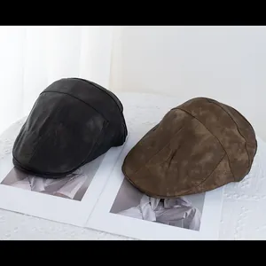 Vintage PU leather beret caps in black and dark brown shown on a magazine and lace