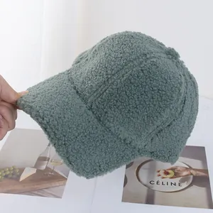Close-up of the thick fleece texture and stitched seams on a green woolly baseball cap