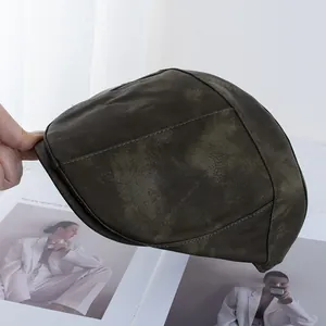 Detail of vintage faux suede beret featuring premium stitching and distressed texture