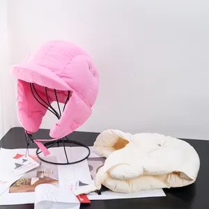Pink and beige down-filled winter trapper hats with ear flaps and secure buckle straps