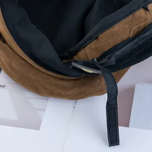 Detailed view of adjustable interior strap and black lining on vintage suede baker boy hat