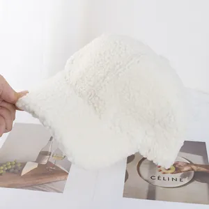 Close-up of white plush faux lamb wool baseball cap showing thick fuzzy texture