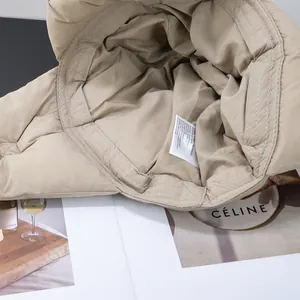 Close-up of the beige winter aviator hat interior lining and fabric care label details