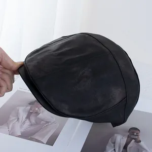 Detailed close-up of premium black PU leather beret with exquisite stitching and texture