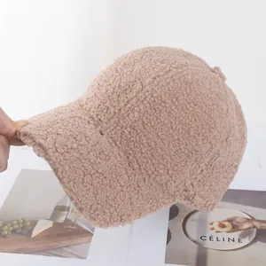 Close-up of soft beige faux shearling baseball cap showing fluffy lamb wool texture