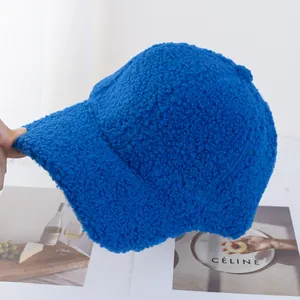 Close-up of soft Klein blue lamb wool baseball cap with fluffy texture and curved brim