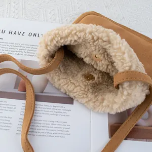 Brown faux suede crossbody bag with cozy faux shearling lining and magnetic buckle