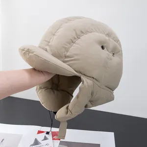 Detail of quilted warm trapper hat with ear flaps and adjustable drawcord for winter