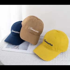 Detailed embroidery of Awesome slogan on cotton baseball caps in navy, khaki and yellow
