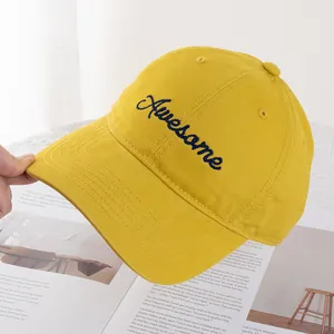 Detailed embroidery of blue Awesome text on bright yellow cotton baseball hat