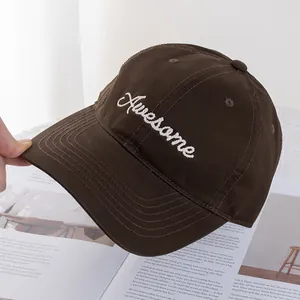 Detail view of American style baseball cap with white Awesome embroidery and curved brim