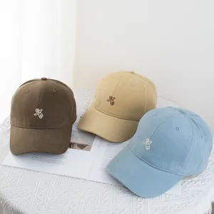 Detailed embroidery of small white astronauts on multi-colored cotton baseball caps