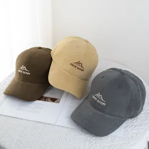 Detail of embroidered mountain logo and 'YOUTH DAYOFF' text on casual cotton baseball caps