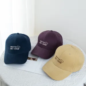 Three oversized baseball caps with bear embroidery in navy, purple, and beige