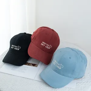 Three cotton baseball caps with bear embroidery in black, wine red and light blue colors