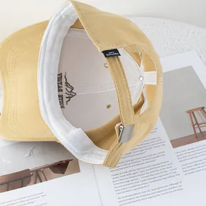 Deep crown yellow cotton baseball cap with adjustable metal buckle and mountain embroidery