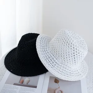 Hollow out straw Panama hat in black and white for sun protection and summer beach vacation