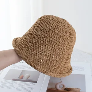 Detail of hollow knit brown bucket hat with crochet texture and rolled brim style