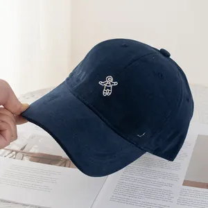 Close-up of white astronaut embroidery on premium navy blue cotton twill baseball cap